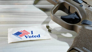Voted sticker next to a Springfield Hellcat pistol. Copyright Guy J. Sagi
